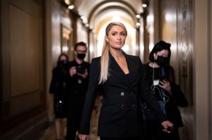 Paris Hilton walks between meeting with lawmakers as she encourages legislation to establish a bill of rights for children placed in congregate care facilities